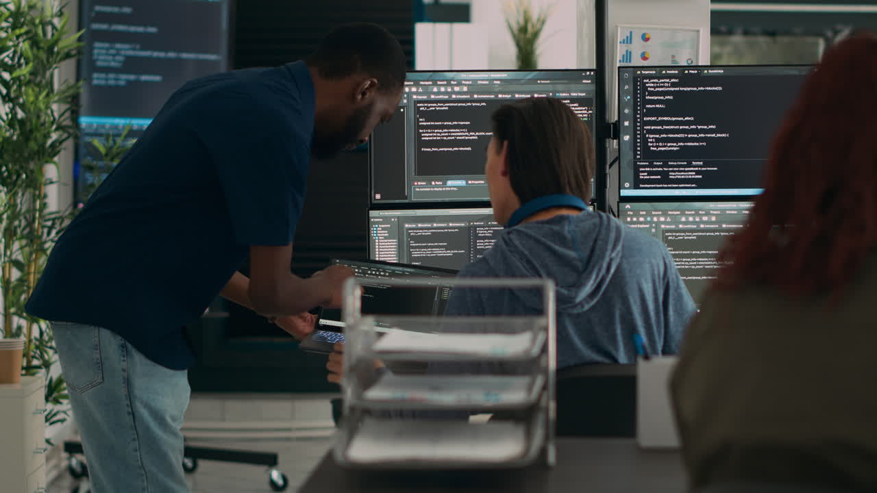 Diverse team of data programers analyzing code programming on laptop