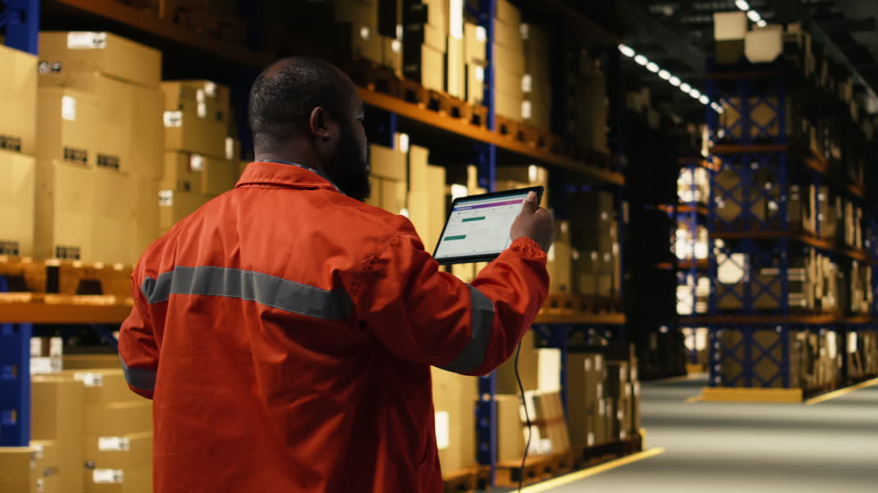 Man staff member scanning packages in modern fulfillment center