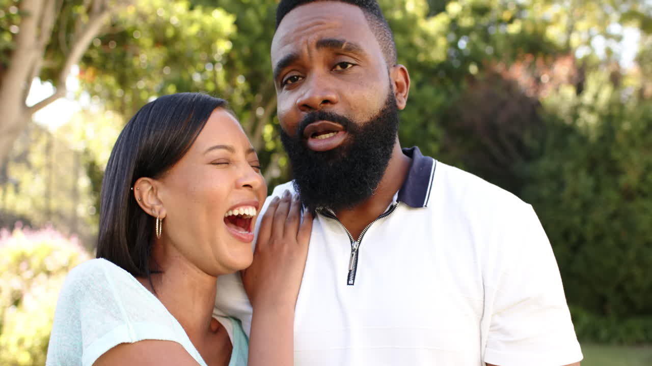 Smiling couple enjoying quality time together outdoors, embracing and talking