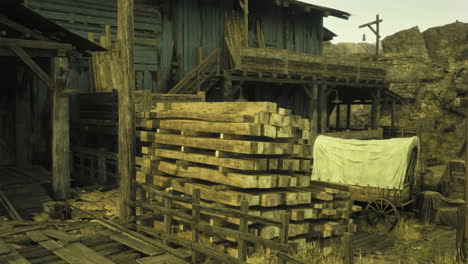 historic wooden structure and stacks of lumber near a wagon in a desert town