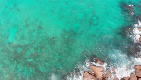 Aerial-view-of-the-white-beaches-and-turquoise-waters-at-Anse-Coco,-Petit-Anse-and-Grand-Anse-on-La-Digue,-an-island-of-the-Seychelles