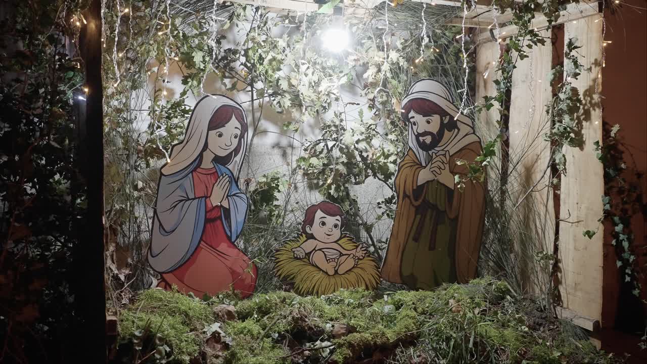 handcrafted nativity scene with cartoon-style figures of Mary, Joseph, and baby Jesus, surrounded by festive greenery