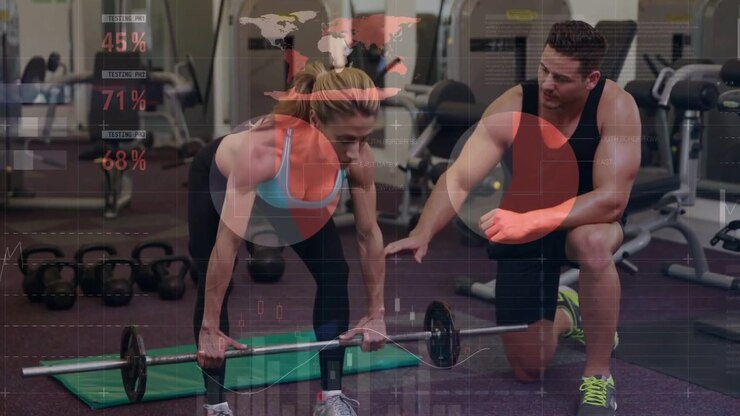 Female client doing hip hinge after trainer cueing, animated percentages guiding form in gym