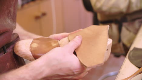 Bespoke-Shoemaker-Measuring-And-Cutting-Leather-For-Shoe