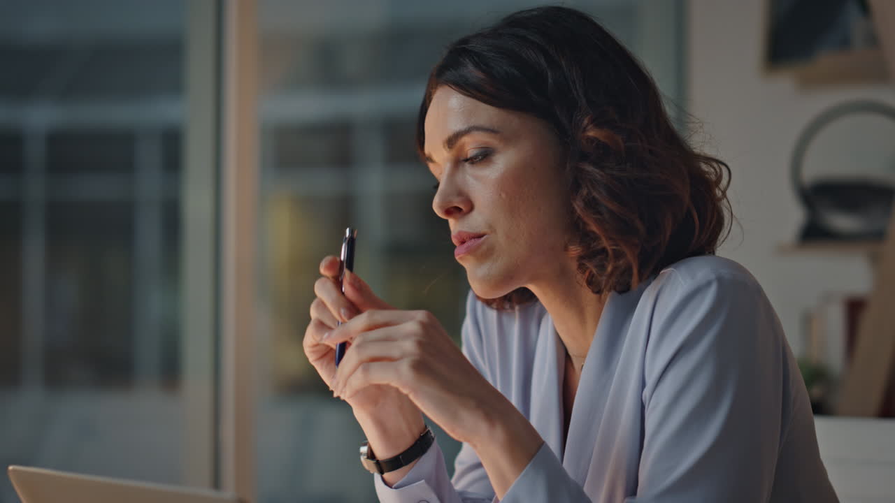 Professional journalist thinking article sitting evening workplace closeup