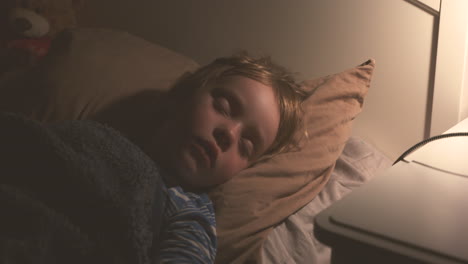 young child sleeping peacefully in bed