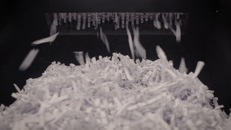 Shredder-Cutting-Paper-From-Below,-Full-Basket