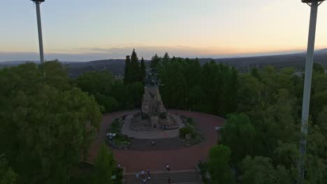 Slow-aerial-rotating-shot-of-tourists-exploring-the-Army-of-the-Andes-monument