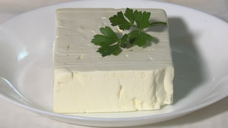 block of feta cheese with parsley
