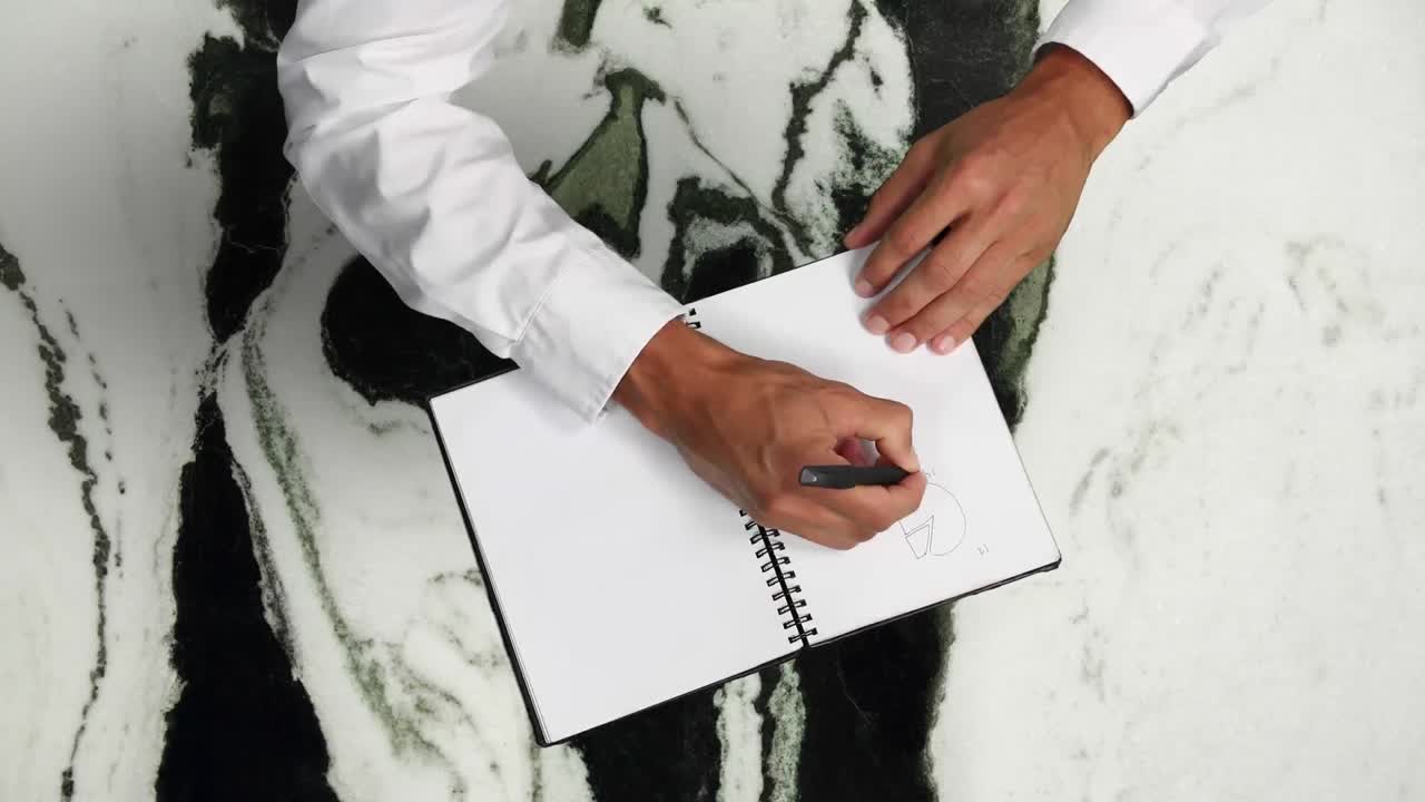 Animation of hands of businessman drawing statistics and writing data