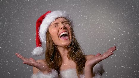 Video-composition-with-falling-snow-over-happy-girl-in-santas-suit
