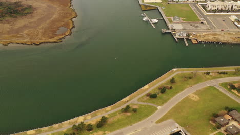 Aerial View of a Coastal Community with Boats and Marshland