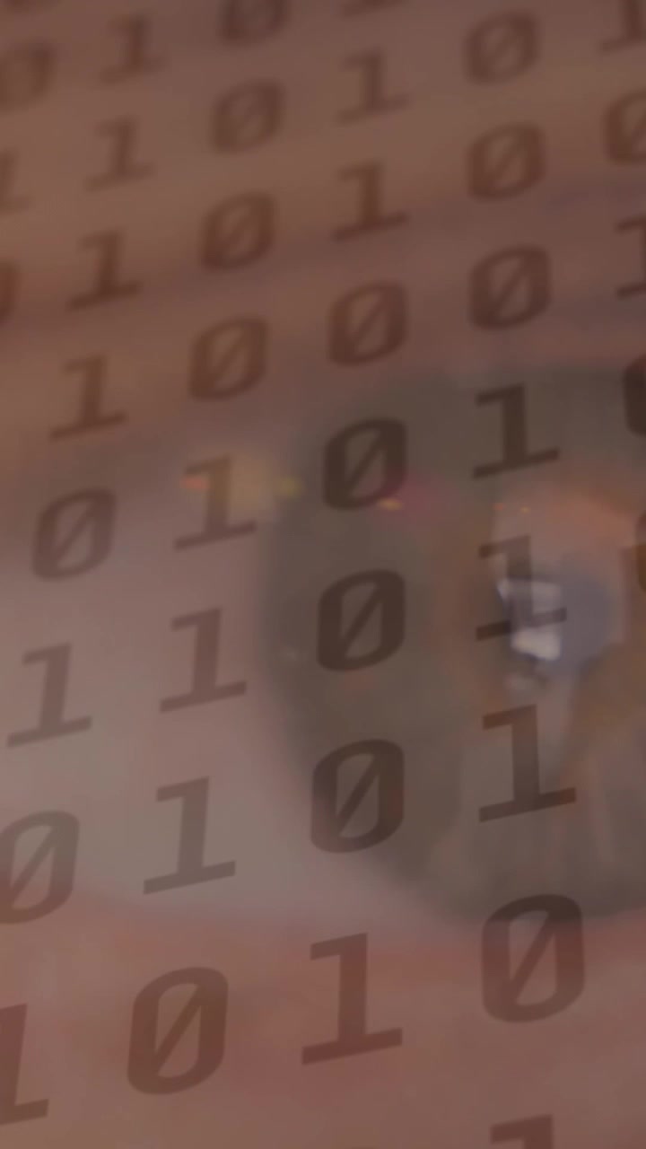 Animation of binary coding data processing over woman's eye