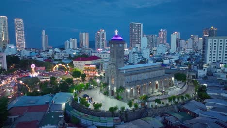 Drone-view-of-the-Main-Cathedral-with-gothic-architecture-in-blue-hour---Nha-Trang-city,-Khanh-Hoa-province,-central-Vietnam