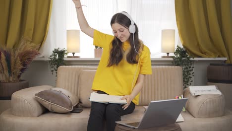 happy female student listening to music.