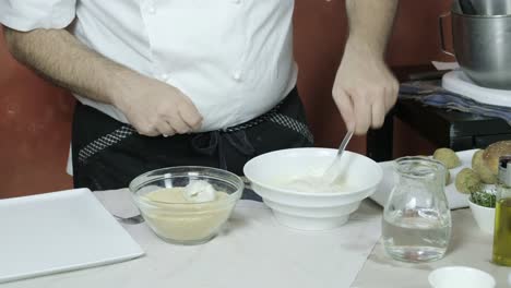 Chef-coating-veggie-balls-with-cornstarch-and-bread-crumbs