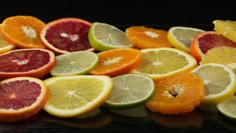 citrus fruits in a section on a black table.