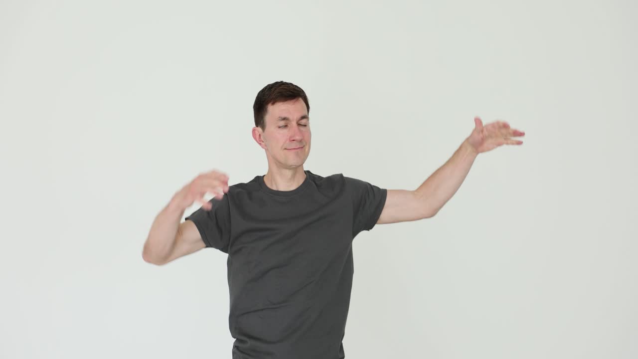 Man flexing and stretching arms on white background