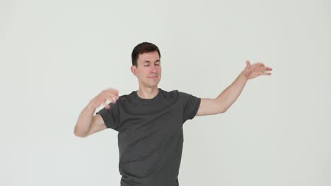 man flexing and stretching arms on white background