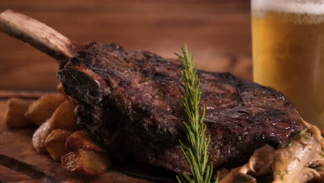 carving board stacked with enormous tomahawk beef steak over roasted potatoes and wild mushrooms, close up slider hd