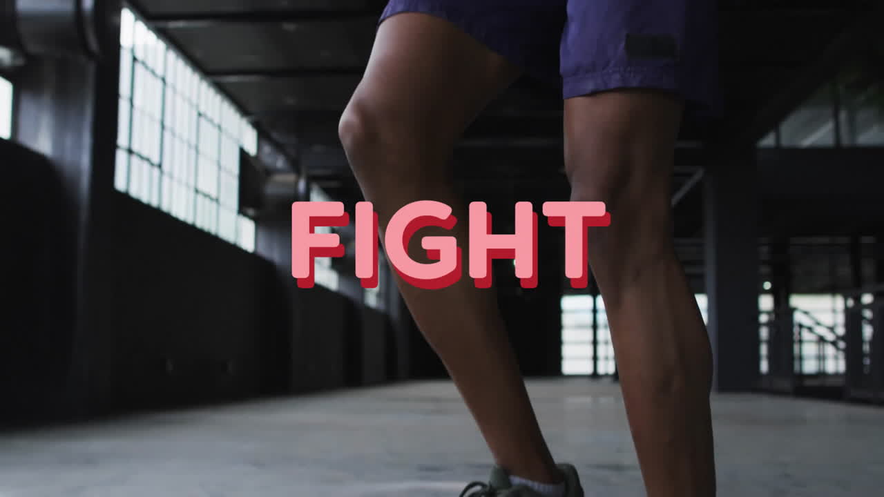 Jumping rope in gym, FIGHT text animation over athlete''s legs