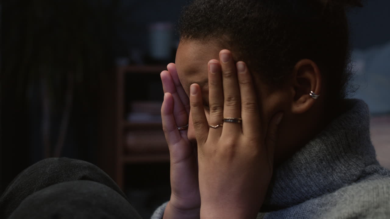 Unhappy girl at her bedroom
