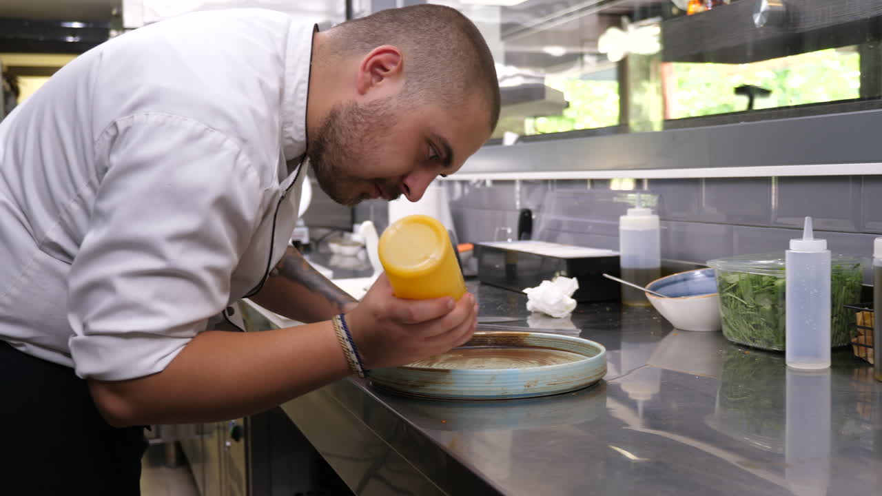 Chef Plating Food in Restaurant Kitchen