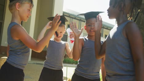 Video-of-happy-diverse-boys-tossing-hats-after-graduation