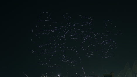 drone show in dark night sky above city forming geometric objects, abu dhabi uae