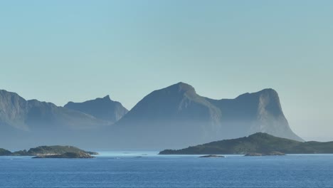Panorama-Of-Mountain-Peaks-On-A-Foggy-Morning-With-Calm-Blue-Waters-In-Bovaer,-Senja,-Norway
