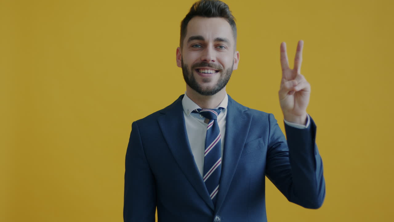 Businessman Smiling and Making Peace Sign