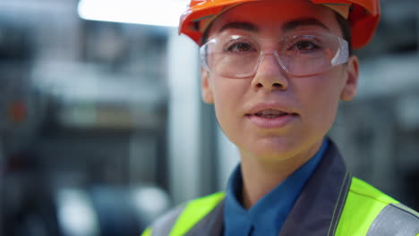 closeup engineer looking camera in manufacturing company. supervisor portrait