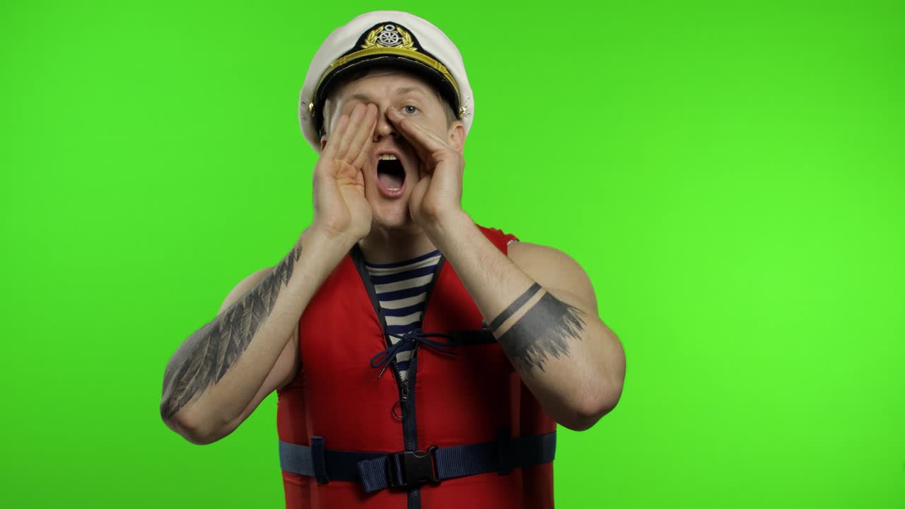 un marinero musculoso trabaja como socorrista en la playa grita a alguien, informa de peligro