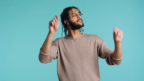 man doing swinging hands, pretending to conduct orchestra, studio background