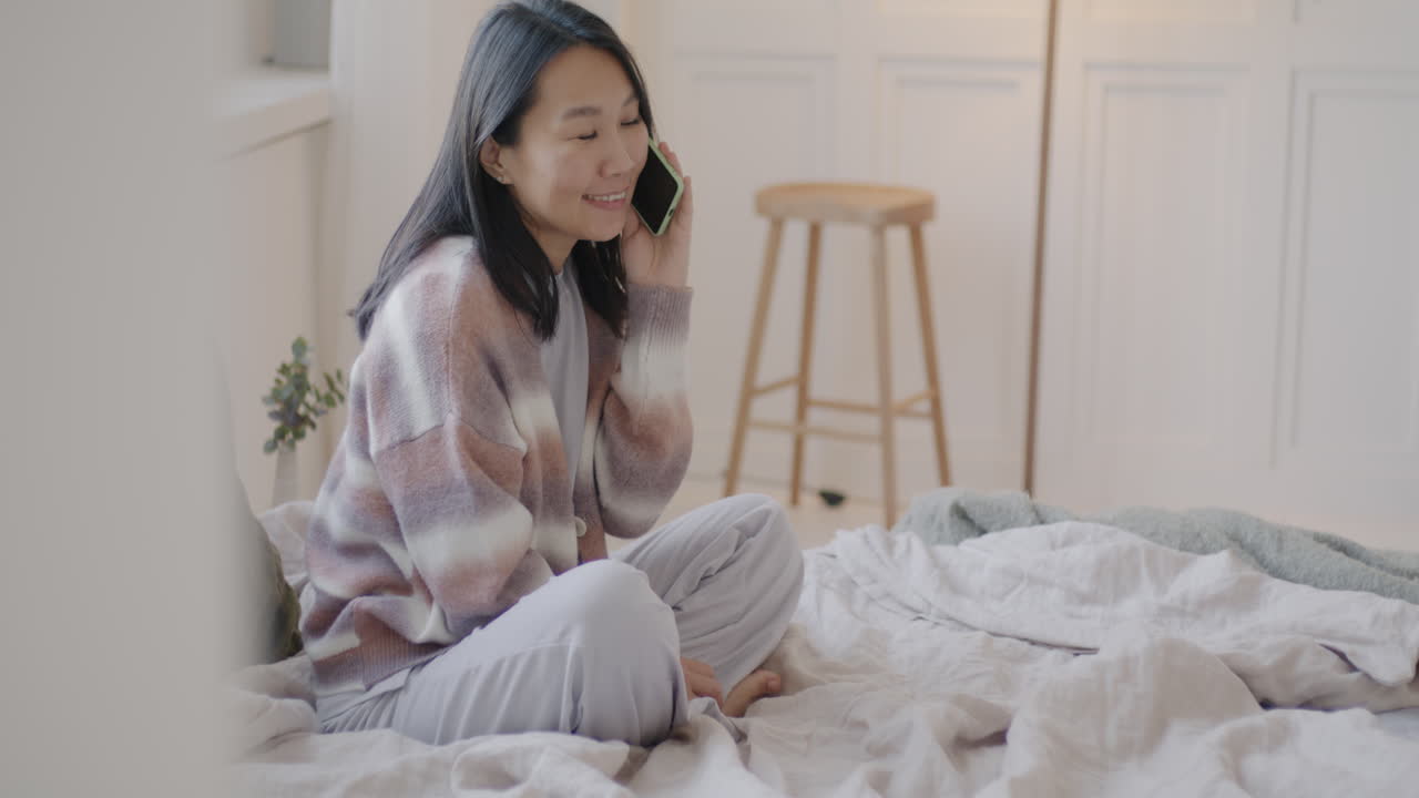 Woman on Phone in Bedroom