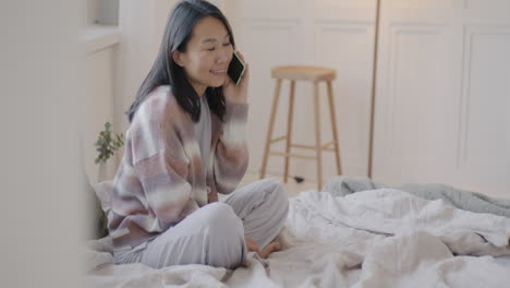 woman on phone in bedroom