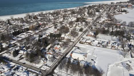 Flying-over-suburban-neighbourhood-in-winter,-St