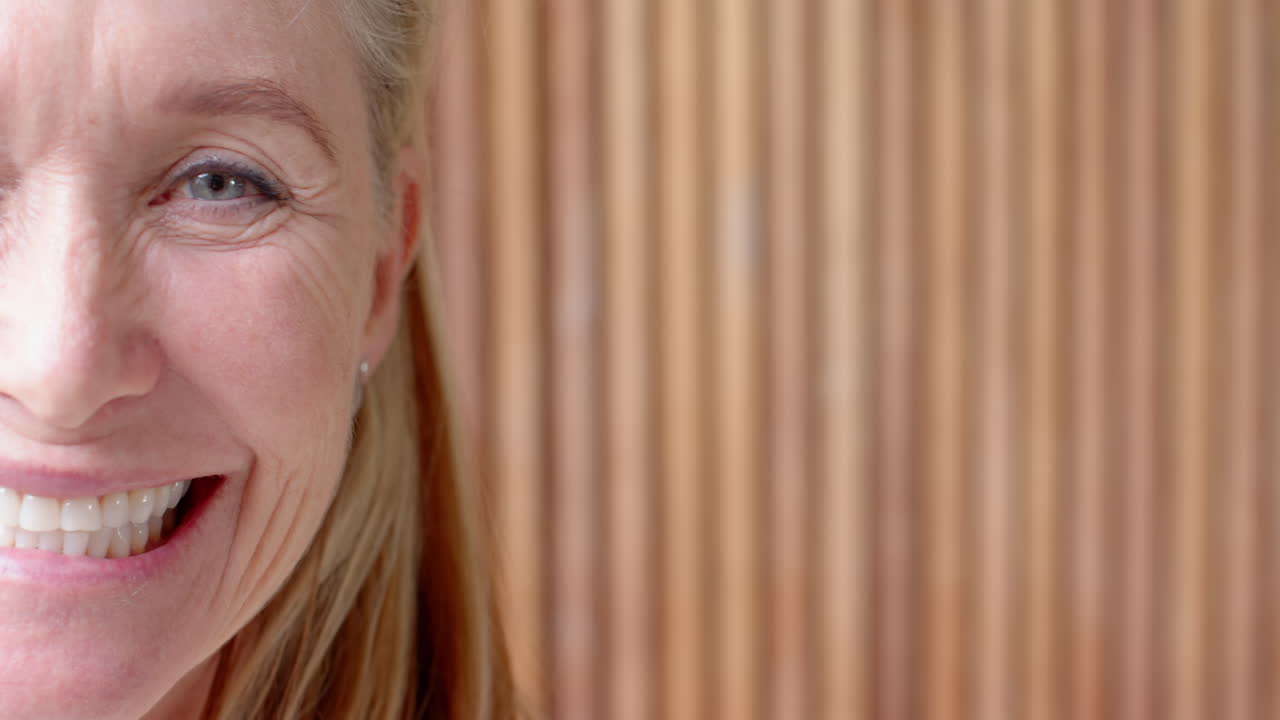 Smiling senior woman enjoying her time, showing happiness and positivity, at home, copy space