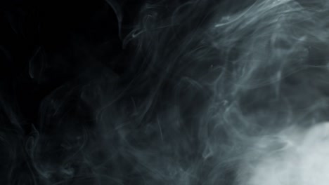 lot of gray smoke on black background.
