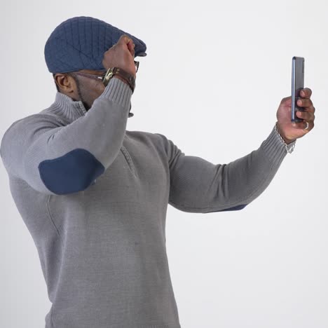african man using smartphone. african man posing shirtless isolated over grey background