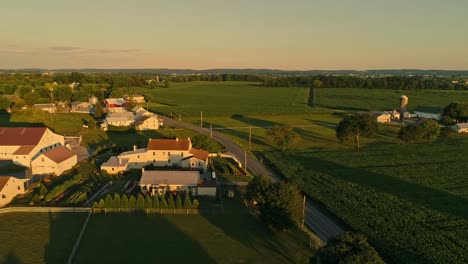 an aerial view of amish farms and fields during the golden hour on a late summer afternoon