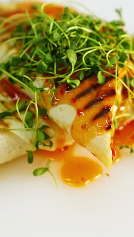 grilled chicken with orange sauce and greens