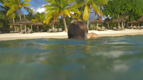 boy diving and making photos with waterproof camera