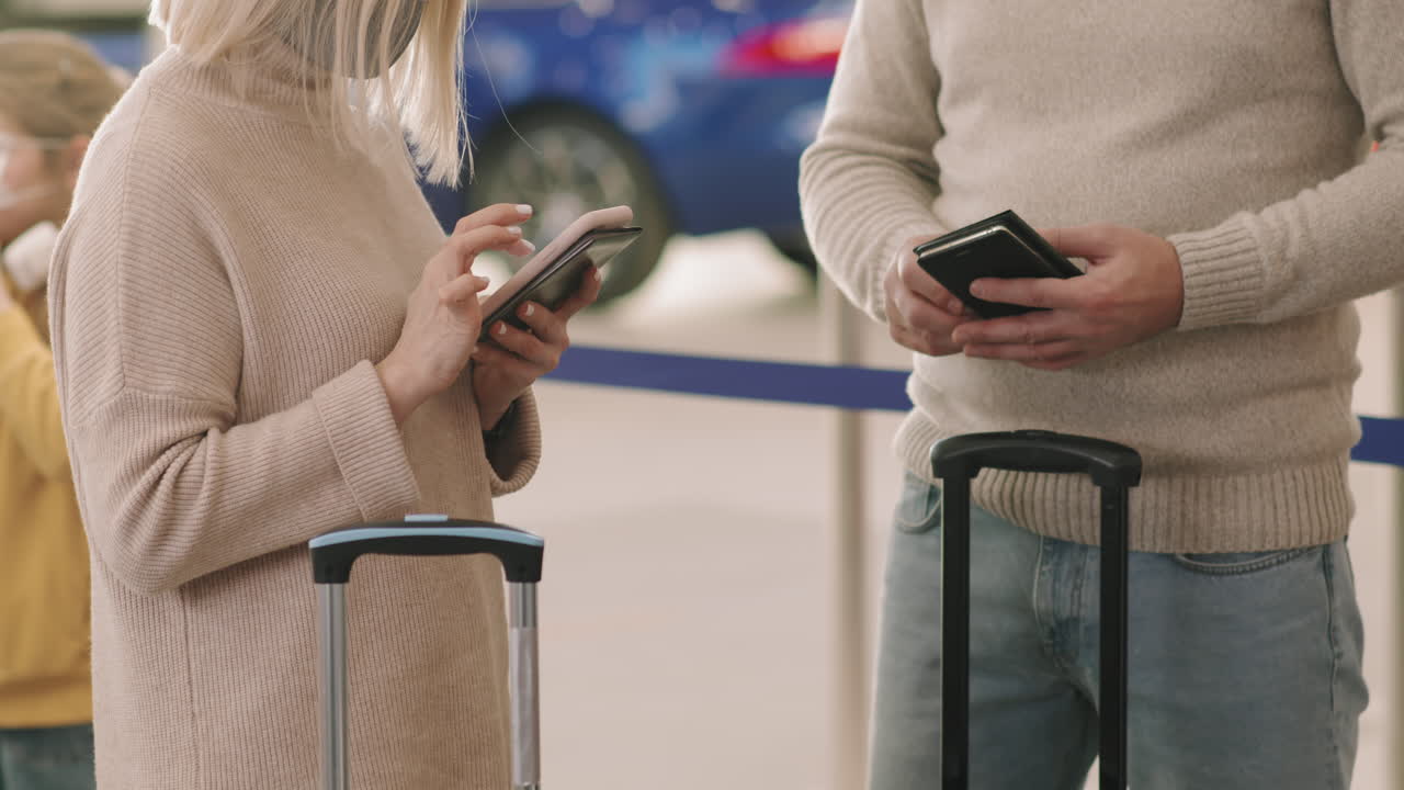 Couple Standing In Queue For Check-In