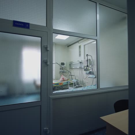 empty medical ward with two empty beds. view through the corridor window on a hospital room with beds and modern medical equipment. protection from dangerous virus