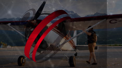 animation of globe and communication rings over man preparing small plane for flight