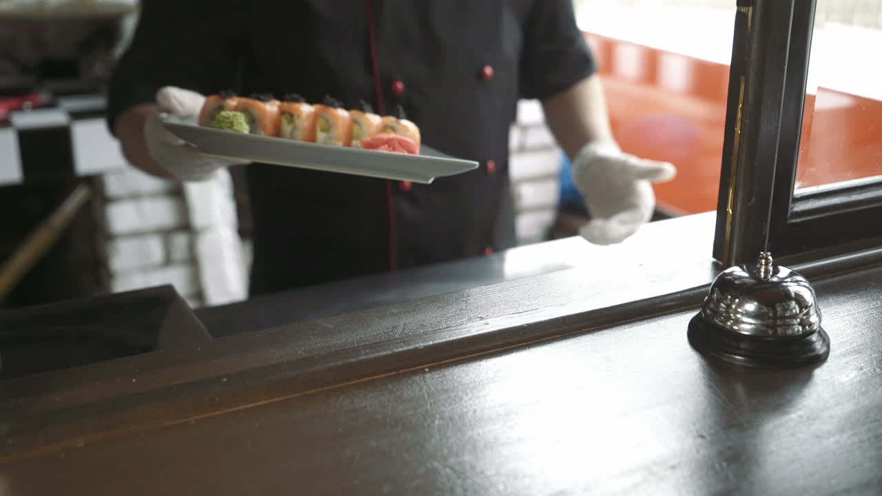 Window serving dishes in the restaurant. Fresh and tasty sushi rolls.