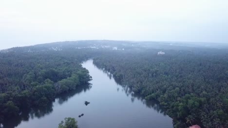 Backwaters-Of-Poovar-River-With-Lush-Vegetation-In-Kerala,-India-During-Daytime---aerial-ascend