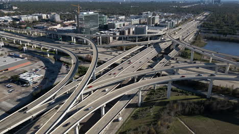 aerial view interstate i-10 freeway and bellway 8 houston texas. establishing shoot of the intersection at i-10 west and sam houston tollway. drone shot of the highway junction i 10 and bellway 8