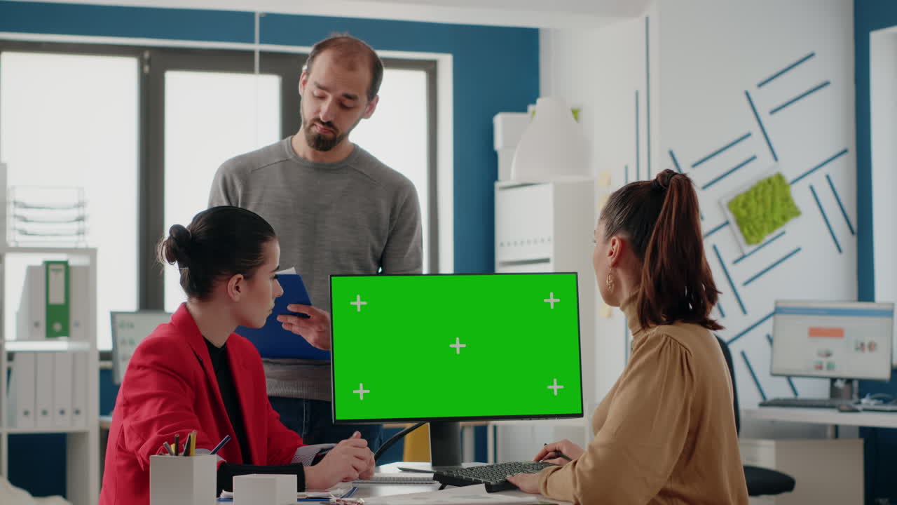 Business people working on computer with green screen